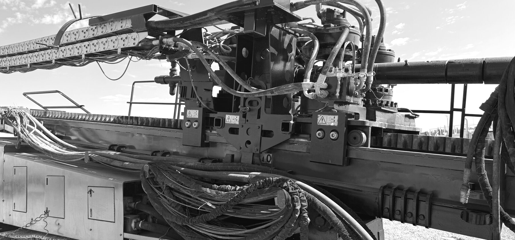 A drill head and gearbox with hydraulic hoses on a horizontal directional drill