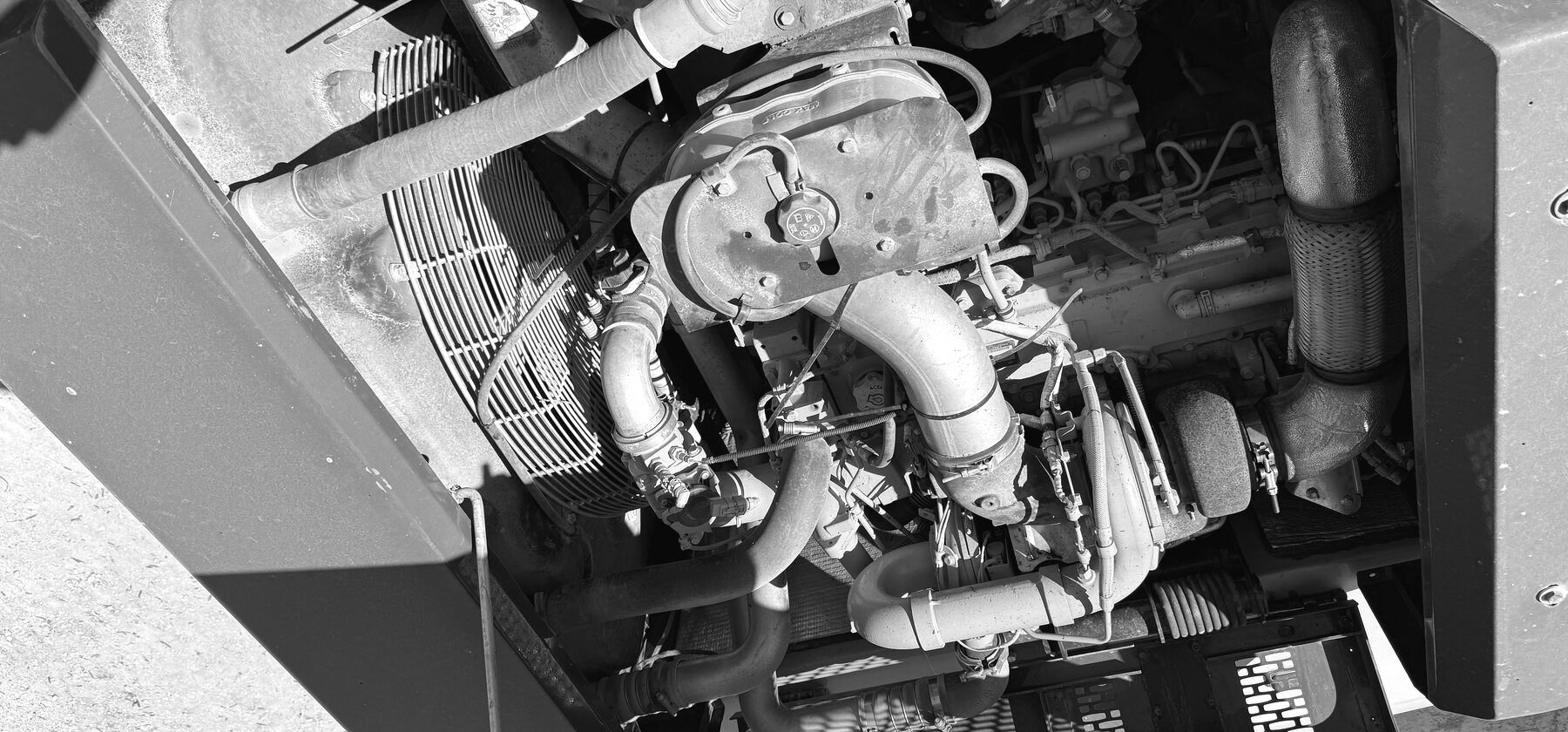 A diesel engine's intake piping and manifold viewed down into an open engine bay