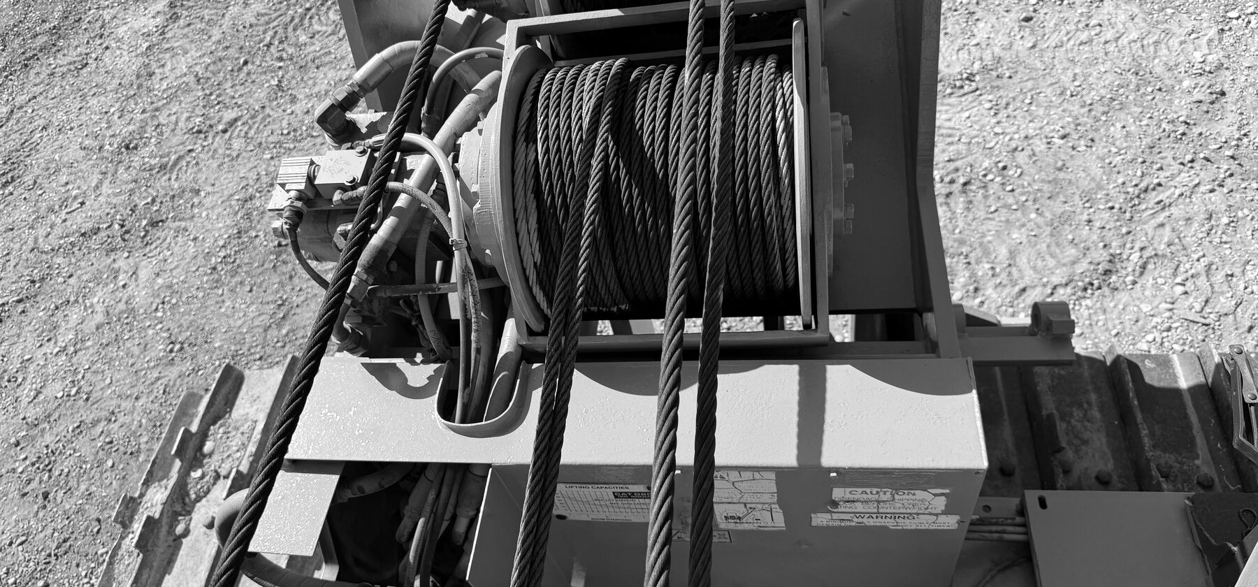 A winch drum wound with steel cable on a vintage crawler tractor