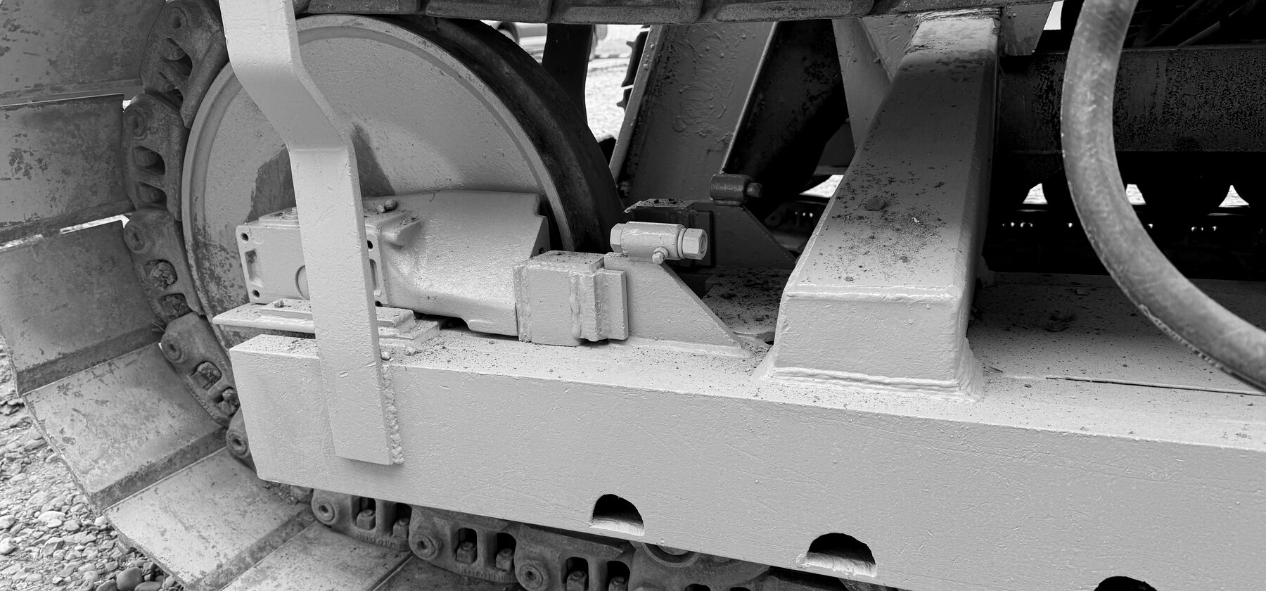 A track idler wheel and roller frame on a wheel trencher's undercarriage
